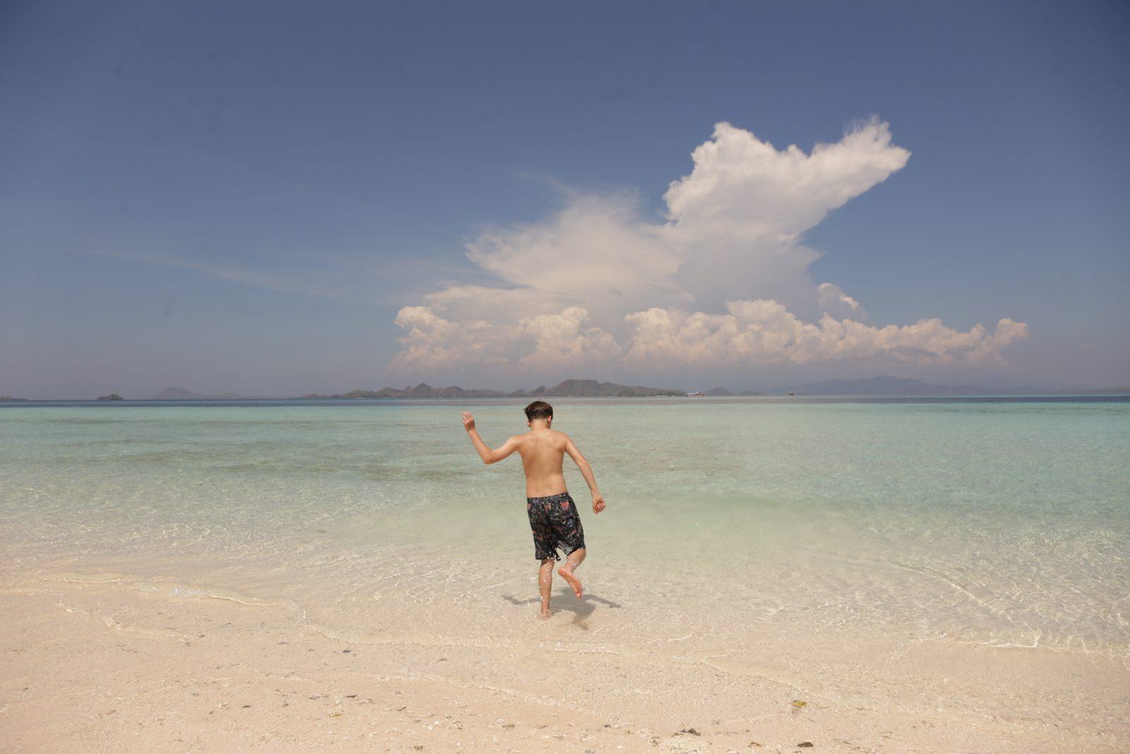 Taka Makassar – man walking on sandbar, cloud behind (Real photo from a Komodo Explorer trip)